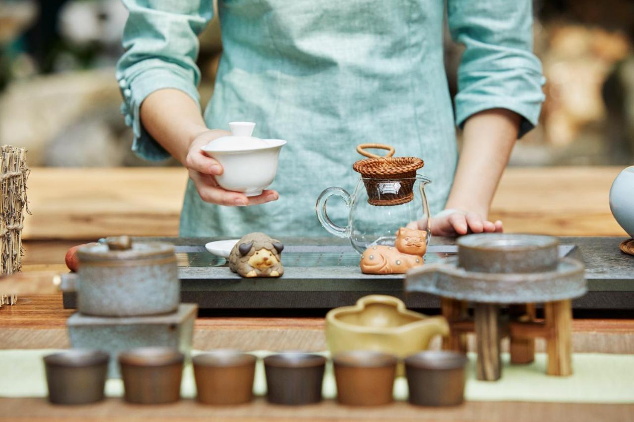 Hyatt Centric Janakpuri New Delhi Hotell Exteriör bild A tea master preparing for a tea ceremony